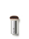 A close-up of the Perfecting Buff brush with a silver handle and densely packed, dual-toned bristles.